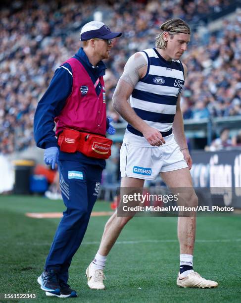 Mark Blicavs of the Cats leaves the field with a leg injury during the 2023 AFL Round 20 match between the Geelong Cats and the Fremantle Dockers at...