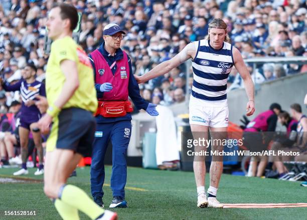 Mark Blicavs of the Cats leaves the field with a leg injury during the 2023 AFL Round 20 match between the Geelong Cats and the Fremantle Dockers at...