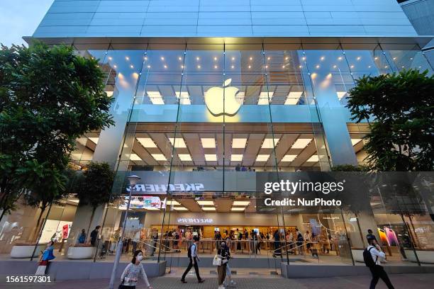 Customers walk past the Apple Store in Causeway Bay in Hong Kong, China, July 25, 2023.