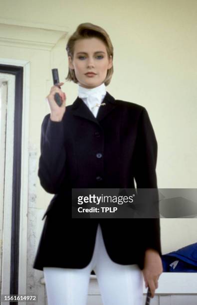 Irish actress Alison Doody, is Jenny Flex, dressed in costume, holds her gun in the stands at Royal Ascot Racecourse during the filming of the 1985...