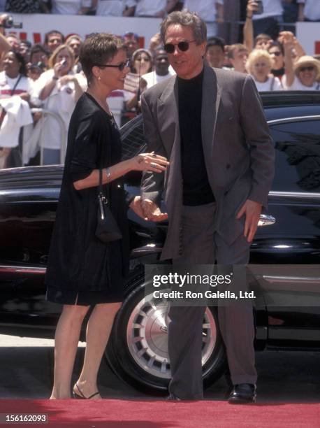 Actress Annette Bening and actor Warren Beatty attend Warren Beatty's hand and footprints in cement on May 21, 1998 at Mann's Chinese Theatre in...