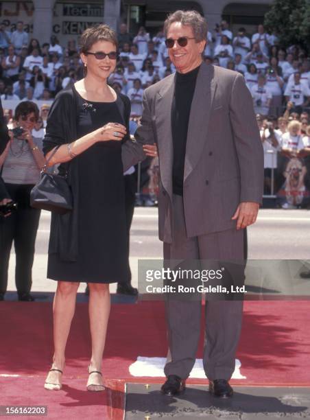 Actress Annette Bening and actor Warren Beatty attend Warren Beatty's hand and footprints in cement on May 21, 1998 at Mann's Chinese Theatre in...