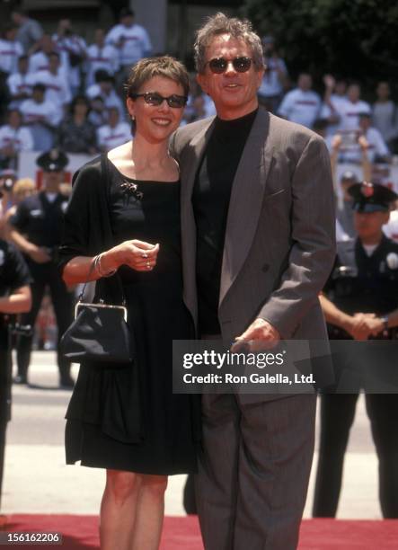 Actress Annette Bening and actor Warren Beatty attend Warren Beatty's hand and footprints in cement on May 21, 1998 at Mann's Chinese Theatre in...