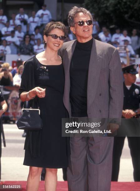 Actress Annette Bening and actor Warren Beatty attend Warren Beatty's hand and footprints in cement on May 21, 1998 at Mann's Chinese Theatre in...