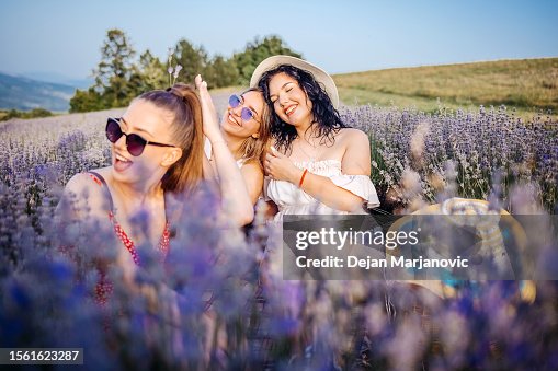 Girls having picnic in lavender field in nature Girls having picnic in lavender field in nature