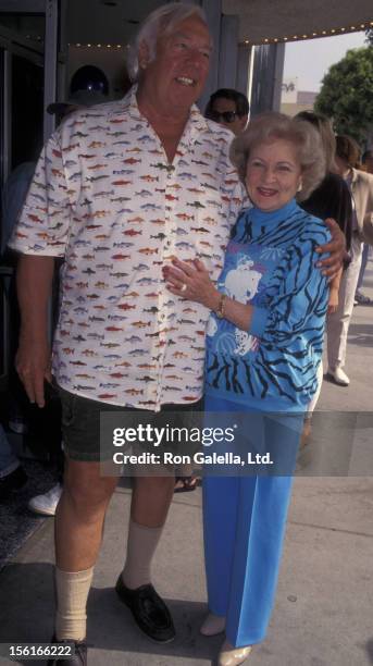 Actress Betty White and George Kennedy attend the premiere of 'Dennis The Menace Strikes Again' on June 27, 1998 at the Mann Plaza Theater in...
