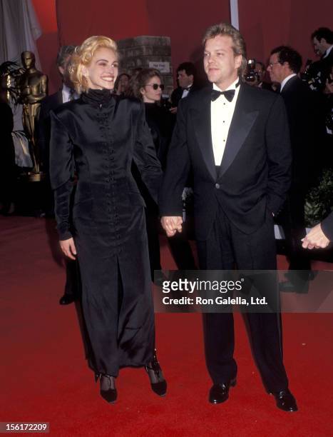 Actress Julia Roberts and actor Kiefer Sutherland attend the 63rd Annual Academy Awards on March 25, 1991 at Shrine Auditorium in Los Angeles,...