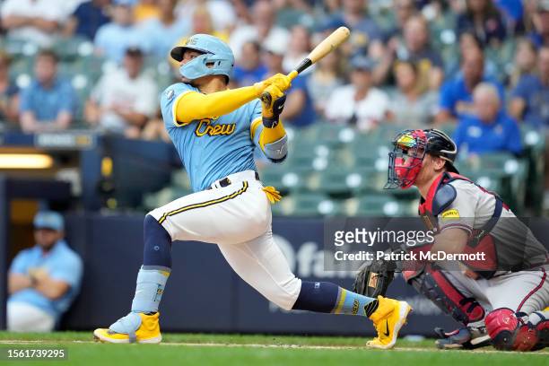 William Contreras of the Milwaukee Brewers hits an RBI double against the Atlanta Braves in the first inning at American Family Field on July 21,...