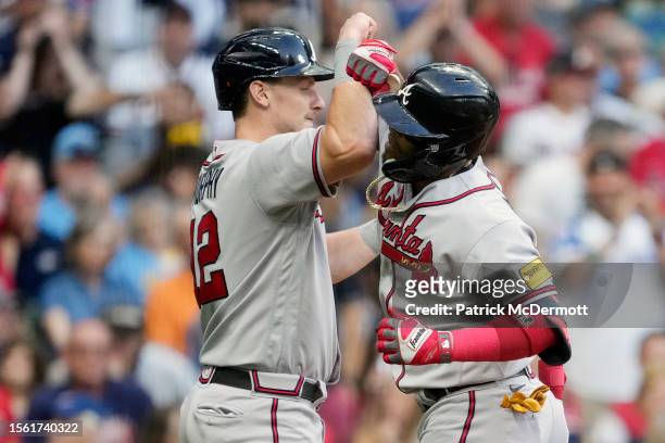 Orlando Arcia of the Atlanta Braves celebrates with Sean Murphy after hitting a two-run home run against the Milwaukee Brewers in the second inning...