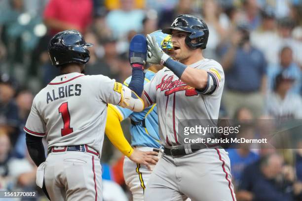 Austin Riley of the Atlanta Braves celebrate with Ozzie Albies after hitting a two-run home run against the Milwaukee Brewers in the third inning at...