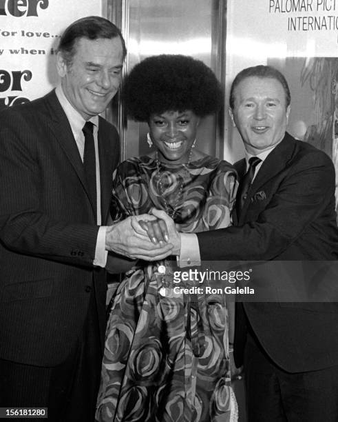 Actor Gig Young, actress/singer Abbey Lincoln and actor Red Buttons attend the premiere of 'For Love Of Ivy' on July 16, 1968 at Loew's Tower East...