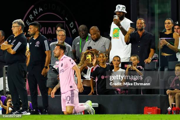 Player Serena Williams and NBA player LeBron James of the Los Angeles Lakers take photos as celebrity Kim Kardashian looks on prior to Lionel Messi...