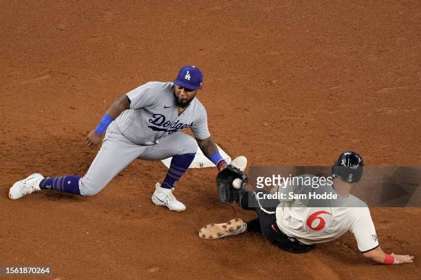 Josh Jung of the Texas Rangers is tagged out by Yonny Hernandez of the Los Angeles Dodgers at second base during the fourth inning at Globe Life...