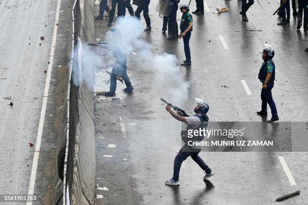 Police fire tear gas shells to disperse Bangladesh Nationalist party activists blocking a highway entering Bangladesh's capital during a protest...