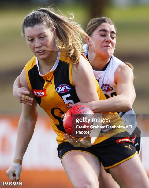 Sophie Butterworth of the Dandenong Stingrays is tackled during the round 15 Coates Talent League Girls match between Northern Knights and Dandenong...