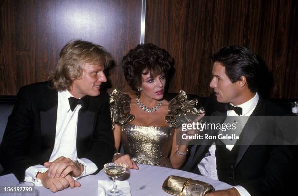 Actress Joan Collins, boyfriend Peter Holm and actor Michael Nader attend the 1983 Carousel of Hope Ball to Benefit the Barbara Davis Center for...