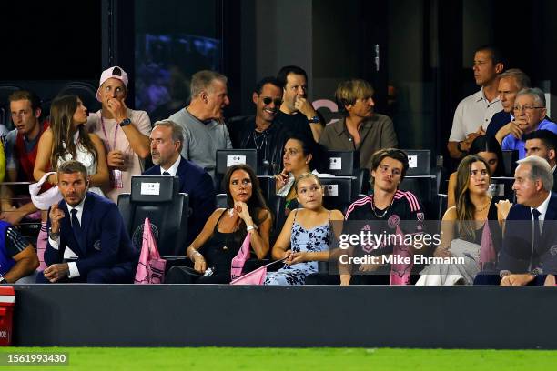 Co-owner David Beckham, singer Victoria Beckham, Harper Beckham, a guest, Cruz Beckham and owner Jorge Mas look on as singer Marc Anthony laughs...