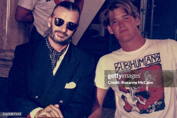 Musician and former Beatle Ringo Starr wearing a double-breasted jacket, sunglasses, ascot, pocket square and rings on his fingers, poses with a crew...