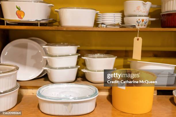 shelves of old-fashioned kitchenware at antique flea market - plastikbehälter stock-fotos und bilder