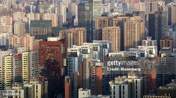 Commercial and residential buildings stand in Beijing, China, on Sunday, Nov. 11, 2012. China's retail sales exceeded forecasts and inflation...