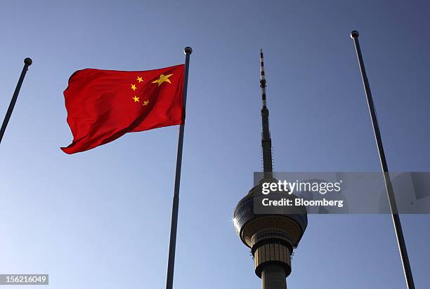 Chinese national flag flies outside the China Central Television Tower Beijing in Beijing, China, on Sunday, Nov. 11, 2012. China's retail sales...