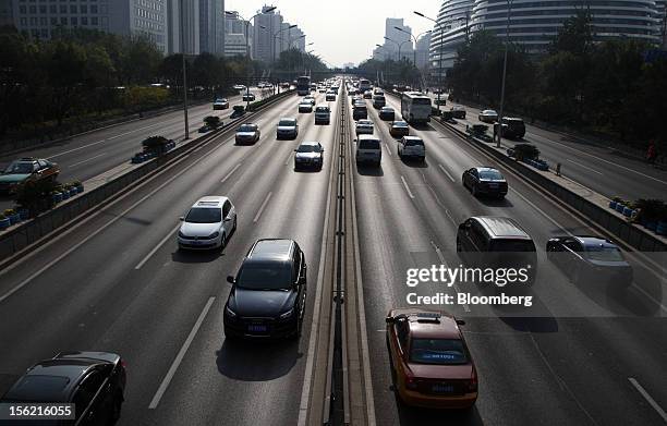 Traffic moves along a road in Beijing, China, on Friday, Nov. 9, 2012. China's retail sales exceeded forecasts and inflation unexpectedly cooled to...