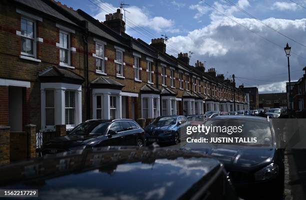 Cars are pictured parked outside a row of terraced houses in Windsor, west of London, on July 29, 2023. Britain's central bank, The Bank of England,...