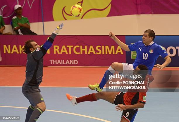 Jairo Dos Santos of Italy battles for the ball with goalkeeper Hema and Ramadan Samasry of Egypt during playoff for their quarter-final match of the...