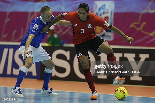 Eslam Shalaby of Egypt looks to pass under pressure from Marcio Forte of Italy during the FIFA Futsal World Cup, Round of 16 match between Italy and...