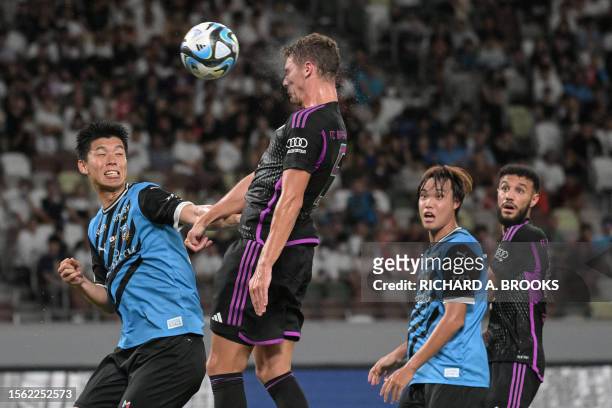 Bayern Munich's defender Benjamin Pavard heads the ball during the football friendly match between Japan's Kawasaki Frontale and Germany's Bayern...