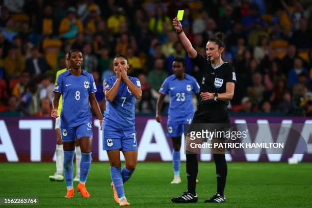 Australian referee Kate Jacewicz shows a yellow card to France's defender Sakina Karchaoui during the Australia and New Zealand 2023 Women's World...
