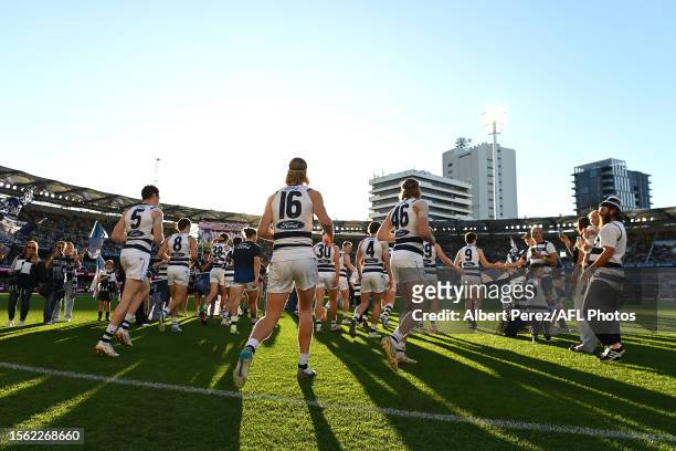 The Cats take to the field during the round 19 AFL match between Brisbane Lions and Geelong Cats at The Gabba, on July 22 in Brisbane, Australia.