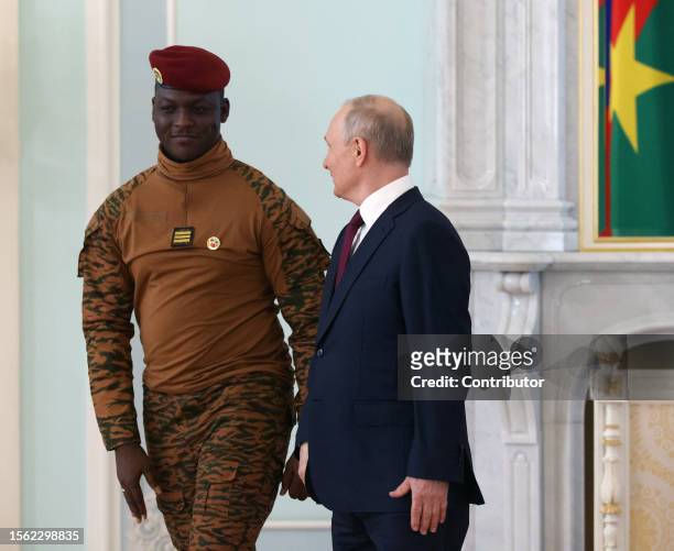 Russian President Vladimir Putin greets Burkina Faso's President Ibrahim Traore during their bilateral meeting on July 29, 2023 in Saint Petersburg,...