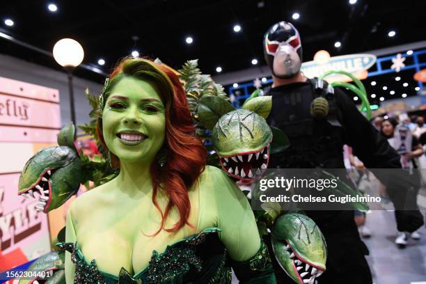 Cosplayer dressed as Poison Ivy poses with another cosplayer at 2023 Comic-Con International: San Diego on July 21, 2023 in San Diego, California.