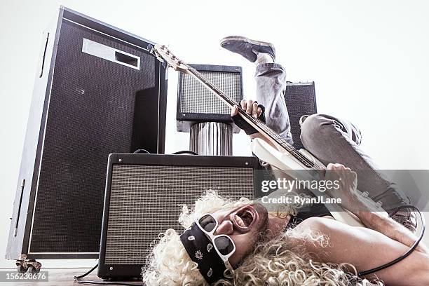 amps and rocking out bass guitar player - rock musician stock pictures, royalty-free photos & images