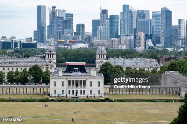 Skyline view of Canary Wharf financial district beyond the National Maritime Museum and the Old Royal Naval College from the viewpoint in Greenwich...