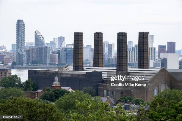 Skyline view looking towards Greenwich Power Station and beyond to high rise housing developments at Canary Wharf on 8th July 2023 in London, United...