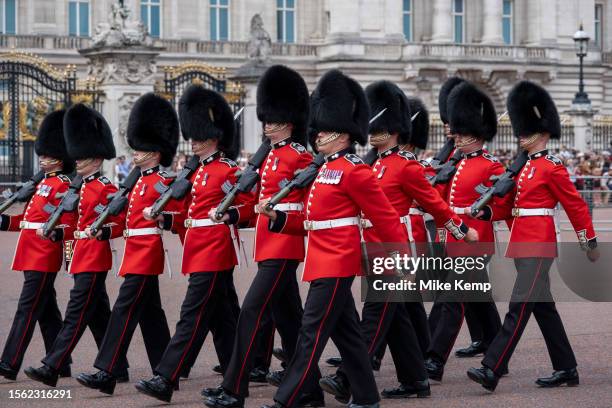 Tourists and domestic visitors at Buckingham Palace watch in huge numbers as Changing of the Guard takes place of the King's Guard comprised of...