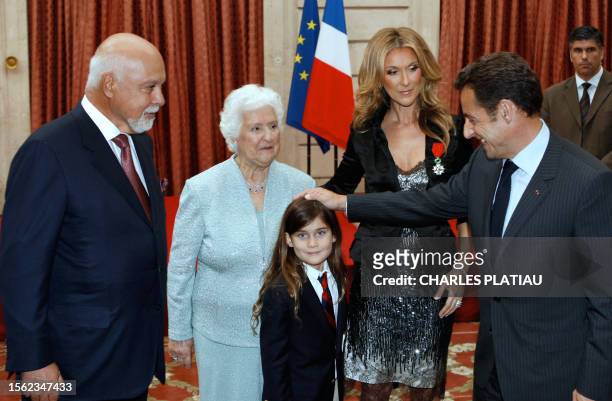 Canadian singer Celine Dion talks with French President Nicolas Sarkozy after she was awarded with France's Legion d'Honneur during a ceremony at the...