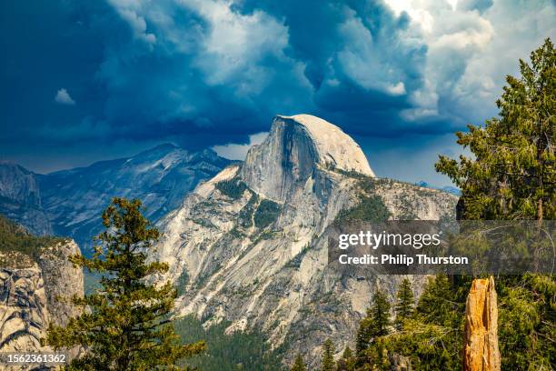 storm forming over half dome in yosemite national park - mariposa stock pictures, royalty-free photos & images