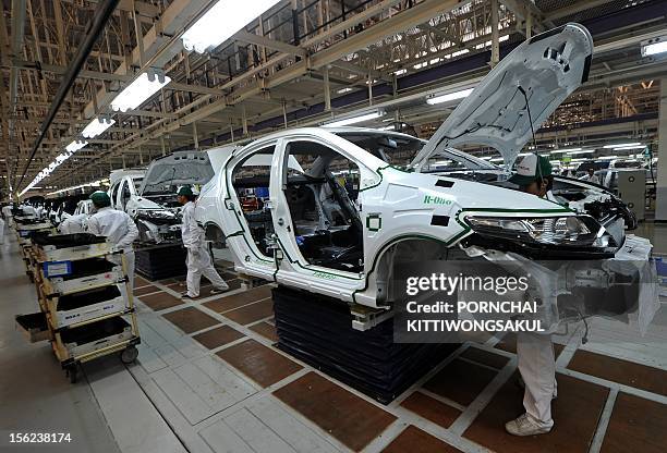 Thai employees work at a Japan's car manufacturer Honda production line after its re-opening in Ayutthaya province on March 31, 2012. The months-long...
