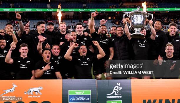 New Zealand's Cam Roigard holds the trophy after the Rugby Championship 2023 and Bledisloe Cup Test match between Australia and New Zealand at the...