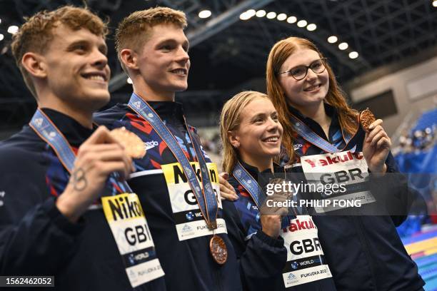 Bronze medallists Britain pose during the medals ceremony for the mixed 4x100m freestyle relay swimming event during the World Aquatics Championships...