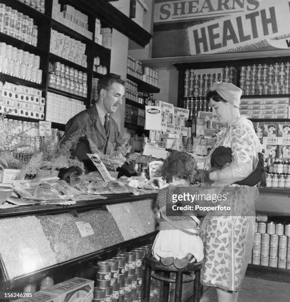 Housewife Mrs Walker buying vegetarian food at her local grocer's, 1947.