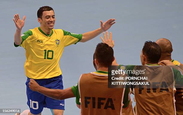 Fernandinho of Brazil celebrates with teammates after scoring a goal against Panama during playoff for quarter-final match of the FIFA Futsal World...