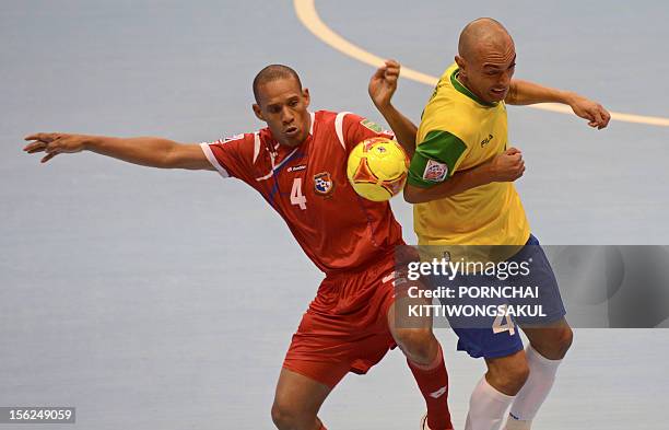 Ari of Brazil battles for the ball with Augusto Harrison of Panama during playoff for quarter-final match of the FIFA Futsal World Cup 2012 in Nakhon...