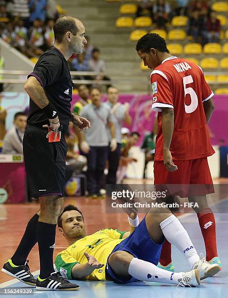 Fernando Mena of Panama stands over Falcao of Brazil after knocking him to the ground during the FIFA Futsal World Cup, Round of 16 match between...