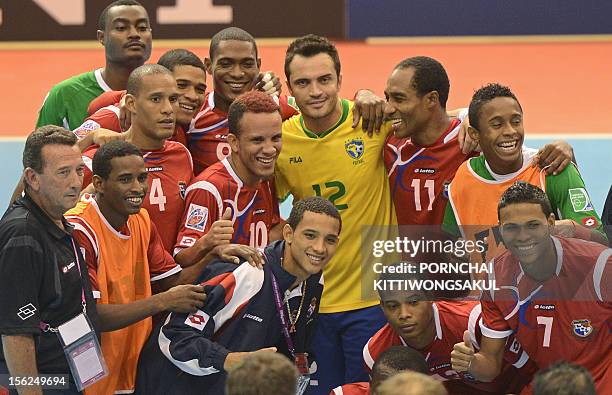 Panama football players pose for ph0tographs with Falcao of Brazil after playoff for quarter-final match of the FIFA Futsal World Cup 2012 in Nakhon...