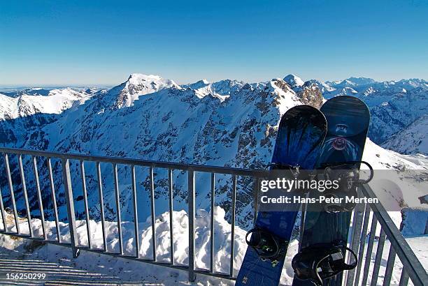 snowboards in front of mountain range - oberstdorf stock-fotos und bilder