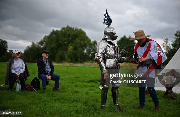 Steve Morris as 'Sir Lancelot' is dressed by his squire ahead of competing in the Legendary Joust jousting event at English Heritage's Kenilworth...